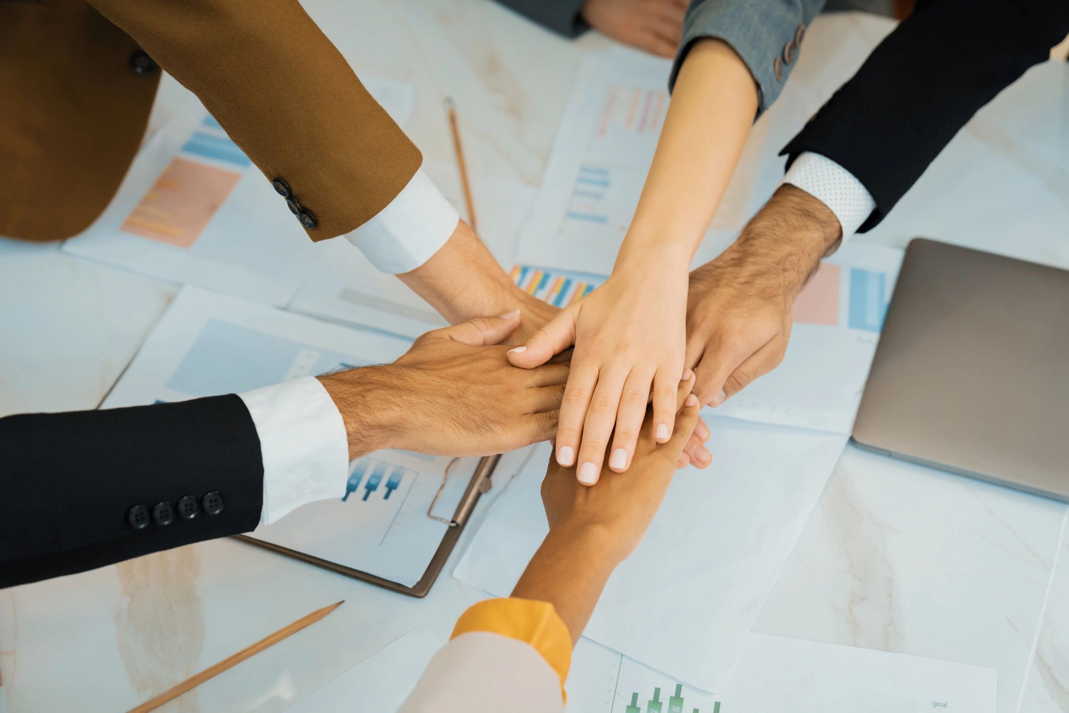 Top view of businesspeople putting hands together